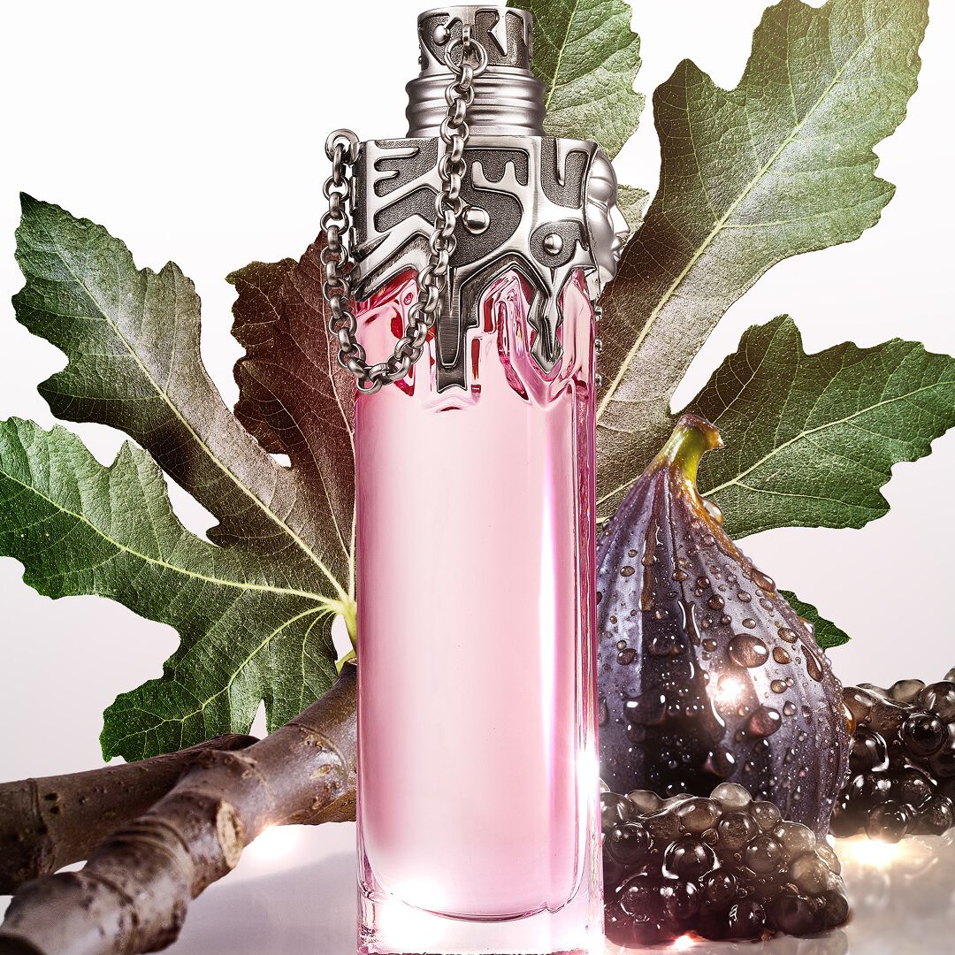 Mugler Womanity pink perfume bottle with fig leaves, fig and caviar pearls​