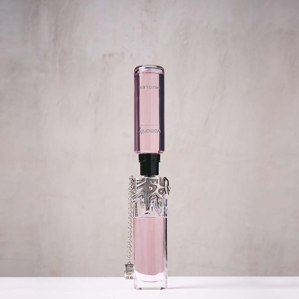 Pink Mugler Womanity refill bottle connected upside down to perfume bottle