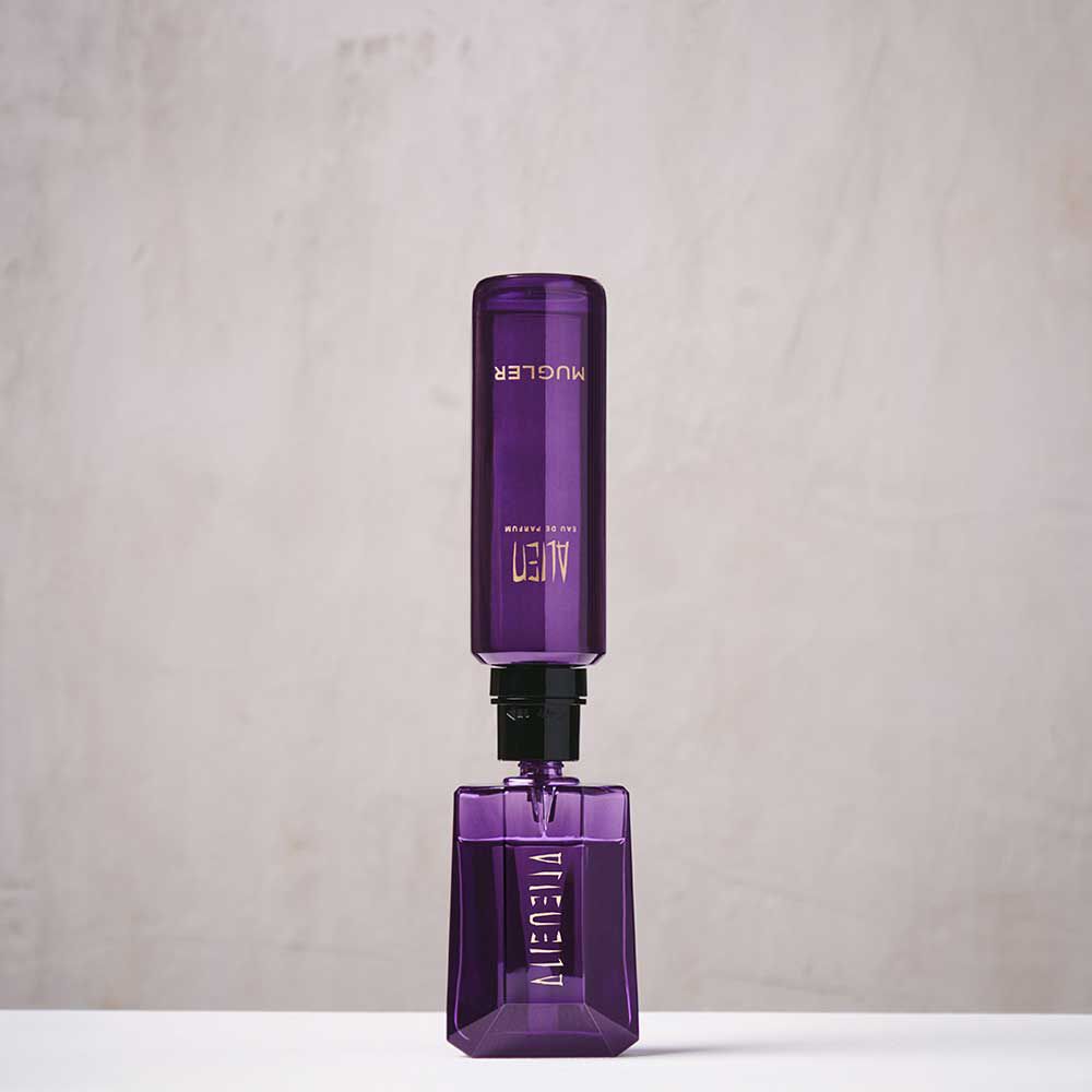Purple Mugler Alien refill bottle connected upside down to matching perfume bottle