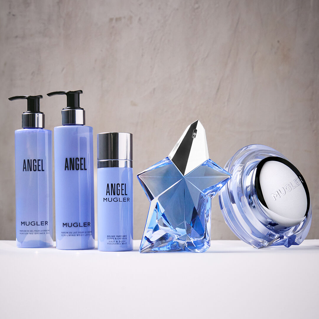 Mugler Angel bath and body products with star-shaped perfume bottle and cream jar on a white surface.