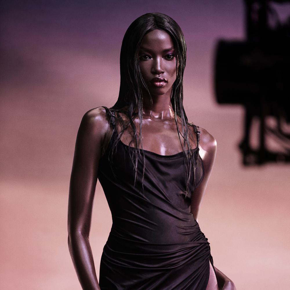 Alien Pulp by Mugler campaign image with model Anok Yai holding the perfume bottle in profile