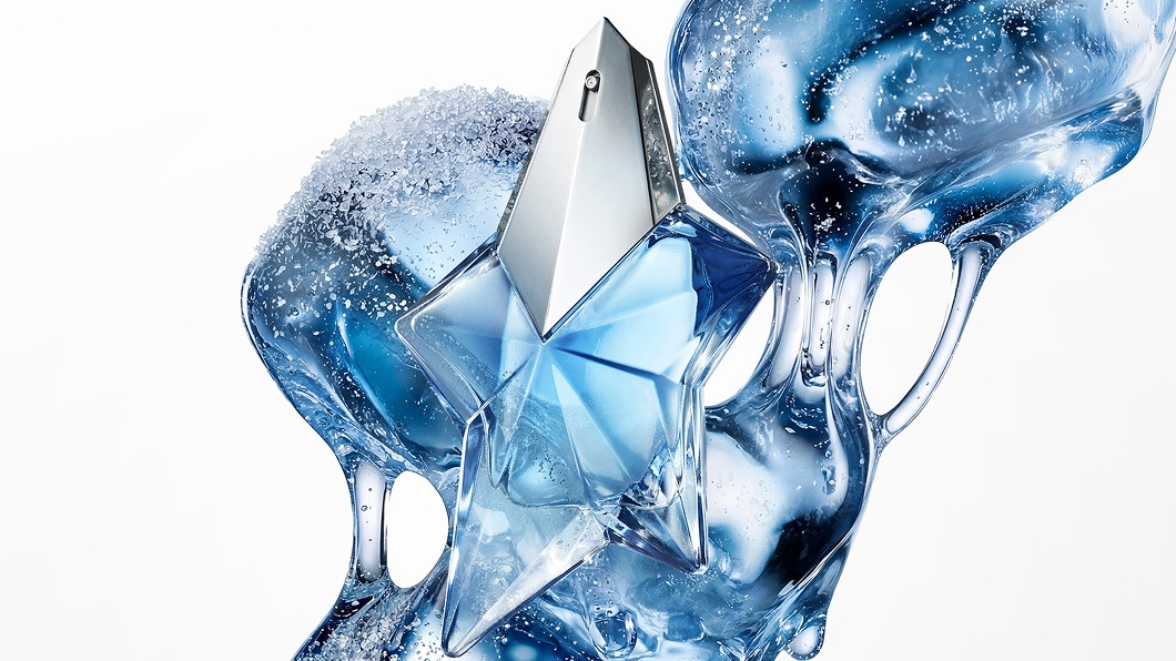 Blue Angel Mugler star perfume bottle with icy, fluid blue abstract backdrop