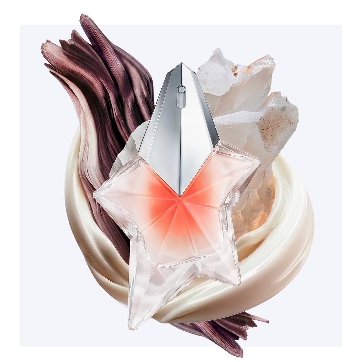 Pink star-shaped Mugler perfume bottle surrounded by glossy cream and crystal textures